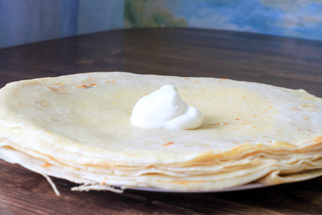 pancakes on a plate with sour cream