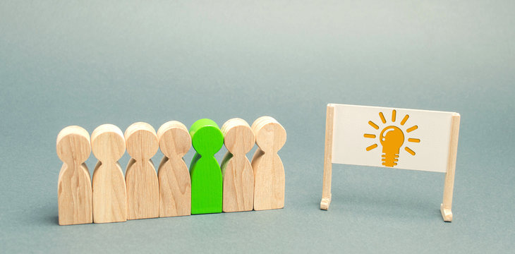 Business team and easel with the image light bulb of an idea. Generating Innovative Ideas. Creative business process. Strategy and Management. Teamwork concept
