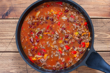 Step-by-step preparation of Chili con carne, step 6 - adding beans and broth to the meat, top view, horizontal