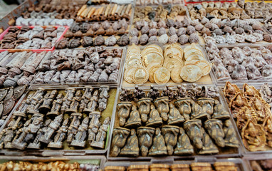 Amulet market stand with Buddha symbols, figurines and talismans, Bangkok. Popular mascot for good luck and success in Asia