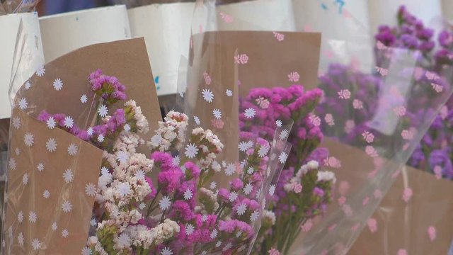A bouquet of flowers in market for sale to gife of congraturation education to students