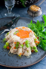 Homemade aspic with chicken, pork peas with slices of carrots, selective focus