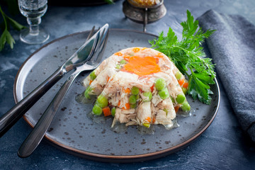 Homemade jelly with chicken, pork peas with slices of carrots, horizontal