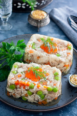 Homemade aspic with chicken, pork peas with slices of carrots, selective focus