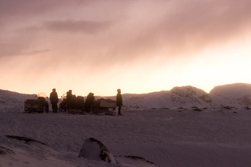 Russia, Murmansk.10.01.2020. a group of researchers in the Arctic tundra, near snowmobiles and a...