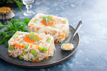 Homemade jelly with chicken, pork peas with slices of carrots, horizontal, copy space