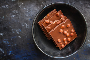 chocolate bar hazelnuts and almonds (delicious sweet dessert snack) menu concept. background. top view. copy space for text