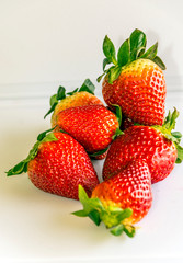 Several strawberries surrounded by white background
