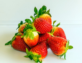 Several strawberries surrounded by white background