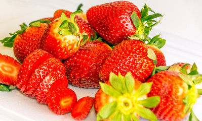 Several strawberries surrounded by white background