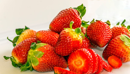 Several strawberries surrounded by white background