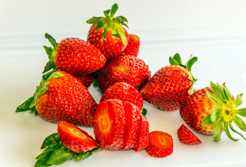 Several strawberries surrounded by white background