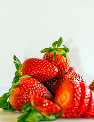 Several strawberries surrounded by white background