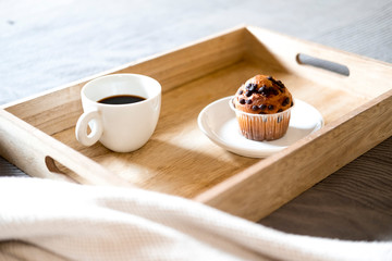 Breakfast in bed with coffee and cupcake