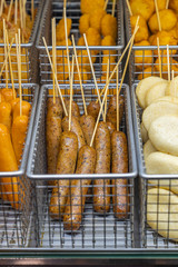 Deep-fried sausage and nugget skewers at street food market