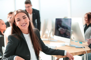 successful young businesswoman sitting at her Desk.