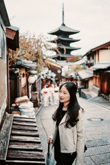 Asian woman is walking on street is Kyoto, Japan