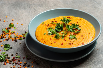 Traditional Indian soup lentils. Indian Dhal spicy curry in bowl, spices, herbs, rustic grey wooden...