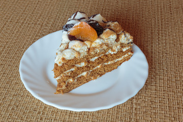 Honey lavender cake made with sponge cake infused with honey and filled with layers of lavender mousse, adorned with dried apricot and plum.