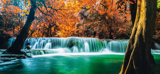 Panoramic exotic colorful Huay Mae Kamin waterfall in autumn forest natural world heritage and famous travel destination. Kanchanaburi province, Thailand.