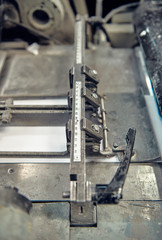 A industrial commercial envelope making machine, making paper envelopes for international distribution. Automated engineering machinery for mass production of paper envelopes.