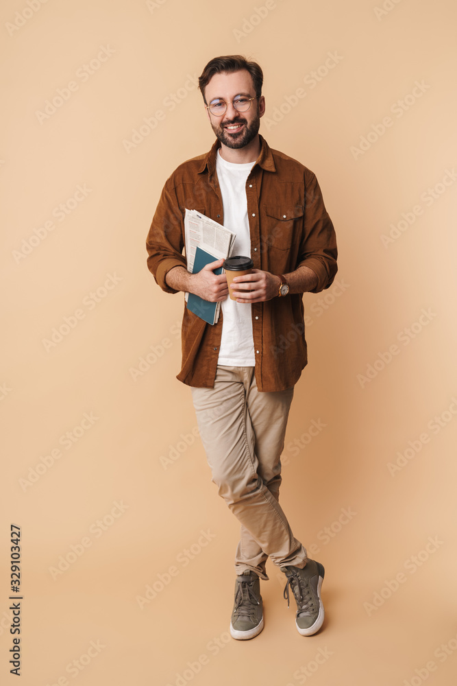 Wall mural Portrait of a cheerful young arttractive bearded man