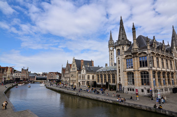 Obraz premium Ghent, Belgium, August 2019. Breathtaking cityscape: from the St. Michael's bridge to the street along the Graslei canal. One of the most beautiful postcards in the city. People stop to watch.