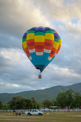 Coroful Hot Air Ballon Flying In The sky with clouds and mountain background