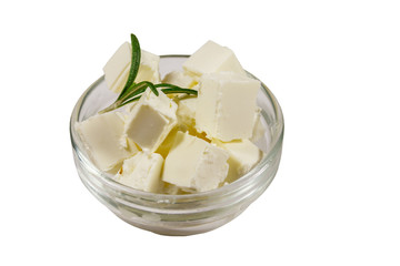 Feta cheese cubes with rosemary in glass bowl isolated on white background