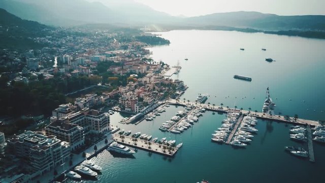 Top view on the marina with yachts near the coastline of the big city