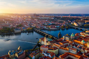 Aerial Prague panoramic drone view of the city of Prague at the Old Town Square, Czechia. Prague Old Town pier architecture and Charles Bridge over Vltava river in Prague at sunset, Czech Republic.