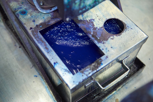 An Industrial Paint And Colour Mixing Machine Mixing Paint In An Industrial Machine. Paint Sliding And Dripping Into Metal Containers In A Colour Mixing And Making Factory