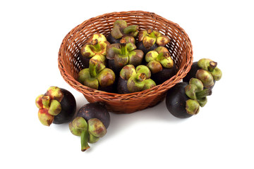 Mangosteen fruits on wicked plate