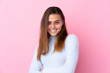 Fototapeta premium Teenager girl with blue sweater over isolated pink background laughing