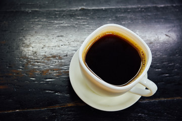 Obraz na płótnie Canvas Espresso in a glass on black wooden table,Top view