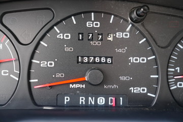 Fuel gauge, vehicle engine temperature, Miles Per Hour Speed indicator, and revolutions per minute indicator on a vehicle dashboard