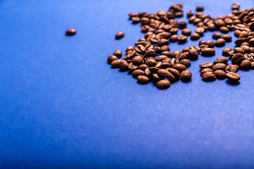 Coffee beans on a blue background. Copy space