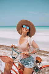 Young woman riding a bike in Holbox, Mexico during her holidays