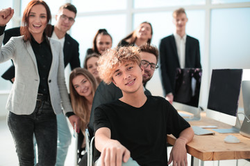 happy business team sitting at the office Desk.