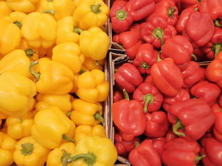 Red and yellow sweet peppers on the store counter