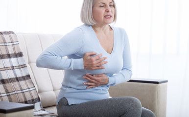 Portrait of middle aged woman having heart attack