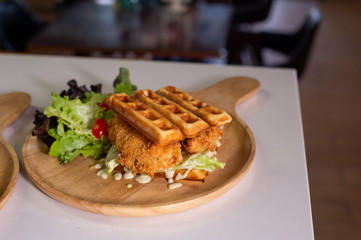 waffles stick with fish stick on wooden table