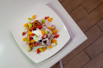 waffles stick with fruit on wooden table