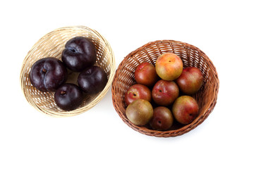 Plums on wicker plate