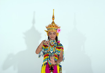 The beautiful woman wearing Thai Tradition southern costume and put headdress on her head,standing on white background,folk dance,black shadow reflection on white background