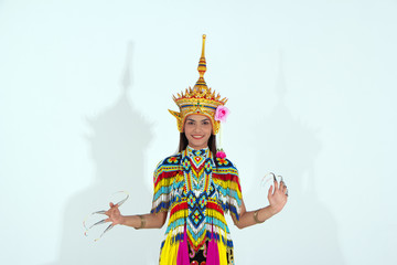 The beautiful woman wearing Thai Tradition southern costume and put headdress on her head,standing on white background,folk dance,black shadow reflection on white background