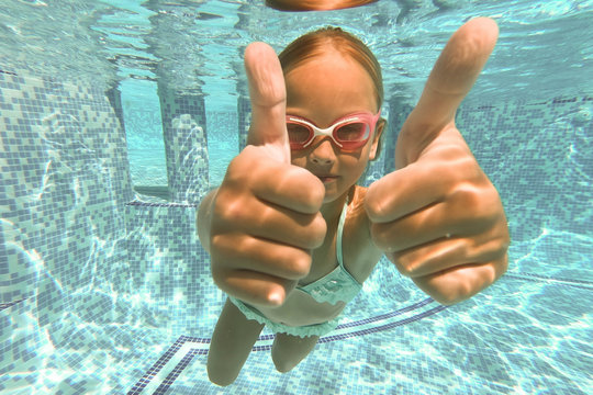 Pretty little girl in swimming pool , summer vacations.
