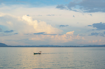 Fishing boat on a background of clouds
