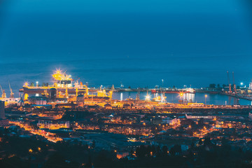 Batumi, Adjara, Georgia. Aerial View Of Urban Cityscape And Port At Evening Or Night. Industrial Zone.