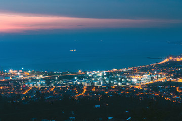 Batumi, Adjara, Georgia. Aerial View Of Cityscape At Evening. Black Sea, Port And Fuel Storage In Night Illumination